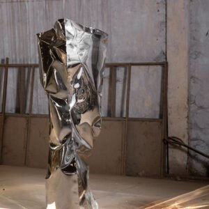 Stainless steel floor sculpture resembling a monolith