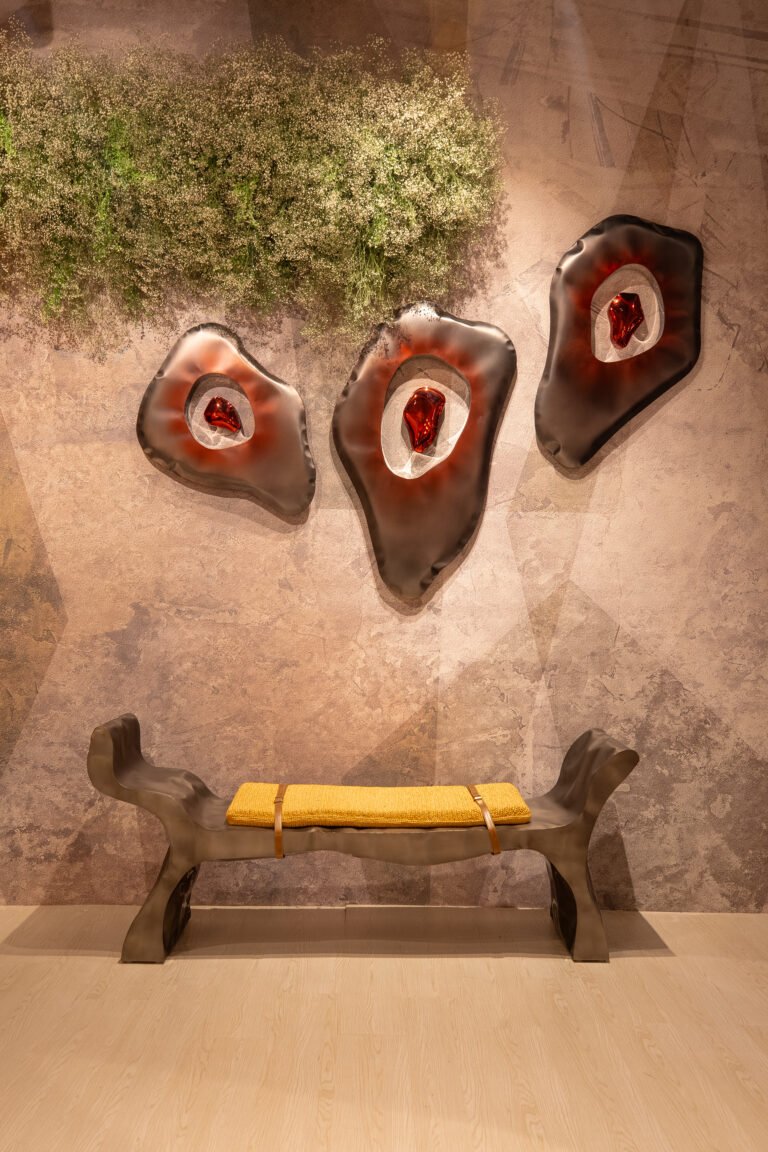 Three piece all art installation in black and red matt and shinny above sculptural bench with raffia seating.