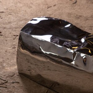 Detail of sculptural bench showing stainless steel mirror finish