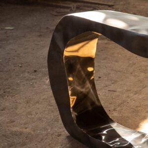 Internal part of the C Sculptural Console showing a shinny reflective finish contrasting with the matte of the outside.