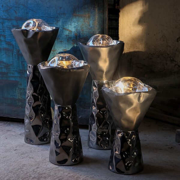 Set of four sculptural floor lights made in stainless steel and blown glass