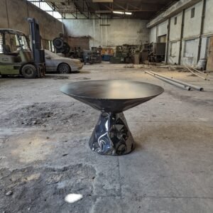 Two piece sculptural dining table int he shape of two inverted cones.
