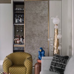 Sculptural floor lamp in matt gold finish in a moder living room area.