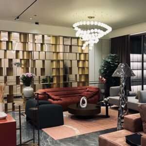 Sculptural floor lamp made of stainless steel in a modern living room.