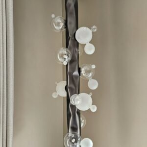 Close-up of the Molecule Pendant Light focusing on the connection of blown glass balls and stainless steel, illustrating the lamp's luxurious and modern design.