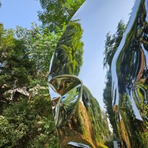 Closeup of stainless steel floor sculpture with reflective finish.