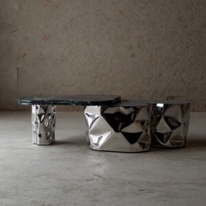Side view of Colgada Coffee Table showing hammered stainless steel base and marble