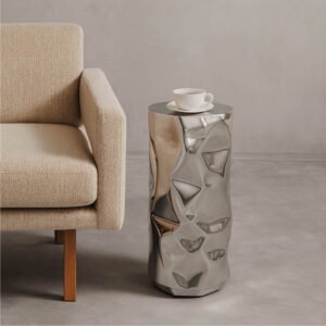 Luxury sculptural stainless steel side table beside armchair – Tronco Drinks Table by Nitush–Aroosh