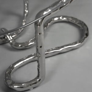 Detail of Lasso Coffee Table stainless steel base with hammered undulating surface