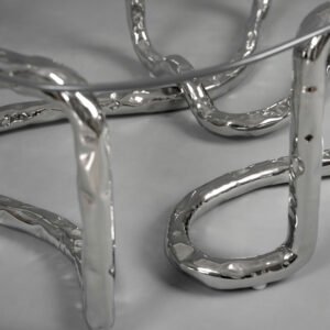 Detail view of Lasso Coffee Table rope-like polished stainless steel legs