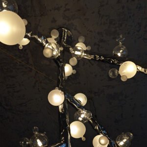 Close-up of Molecule Canopy Light glass globes — mix of frosted and clear blown-glass spheres clustered on polished stainless-steel branches