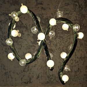 Close-up of Molecule Lasso Light – sculptural stainless-steel chandelier with blown-glass globes