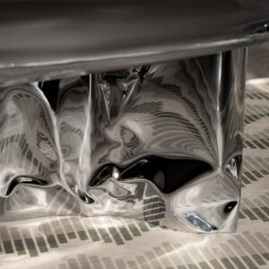 Reflective detail of Pebble Coffee Table stainless steel base with abstract distortions